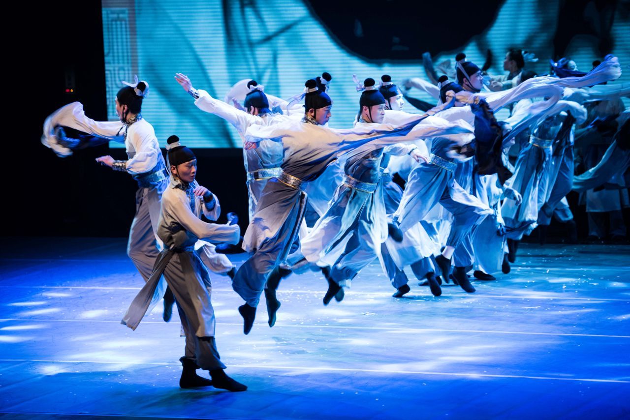 Chinese dancers leap through the air on stage during a performance for the Qatar-China 2016 Opening Ceremony.