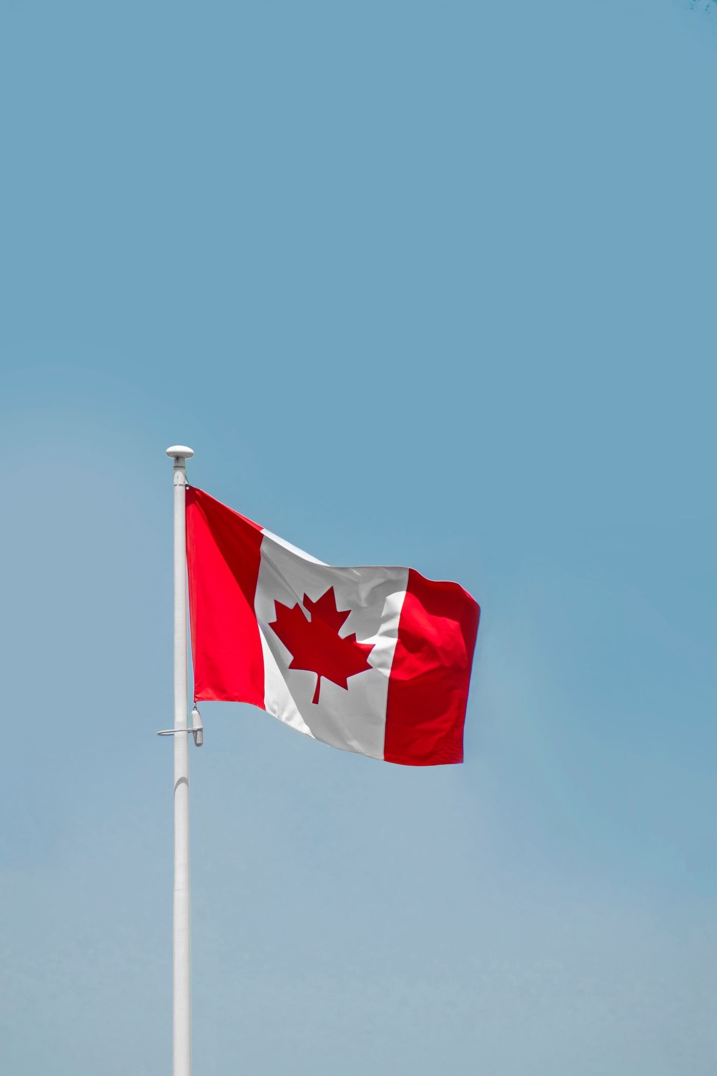The National Flag of Canada, commonly known as the Maple Leaf flag or l'Unifolie, fluttering in the sky