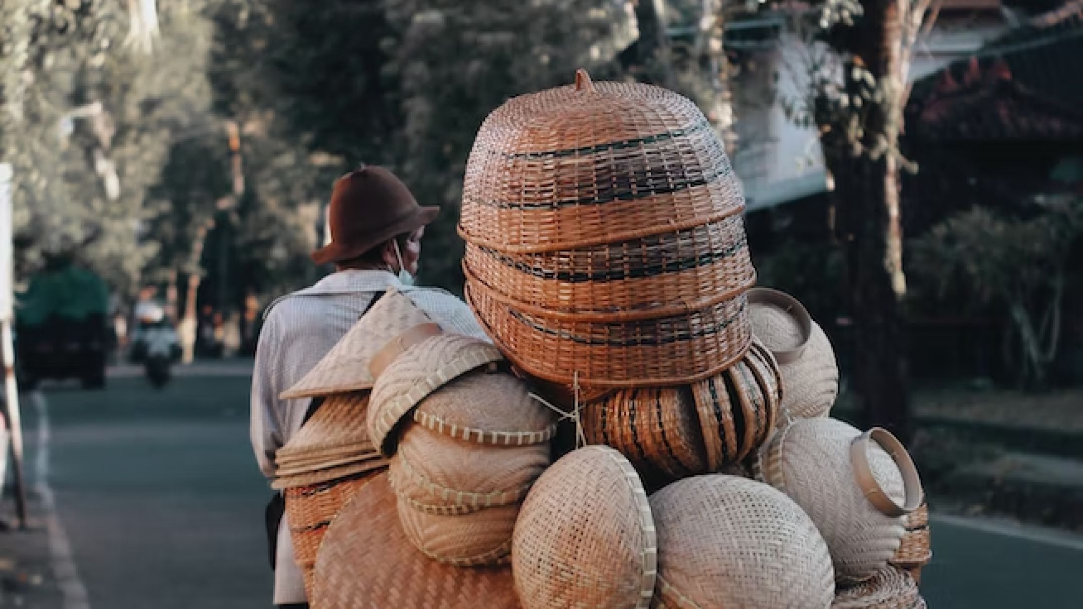 A man carries traditional Indonesian woven baskets. Qatar-Indonesia Photography Journey.