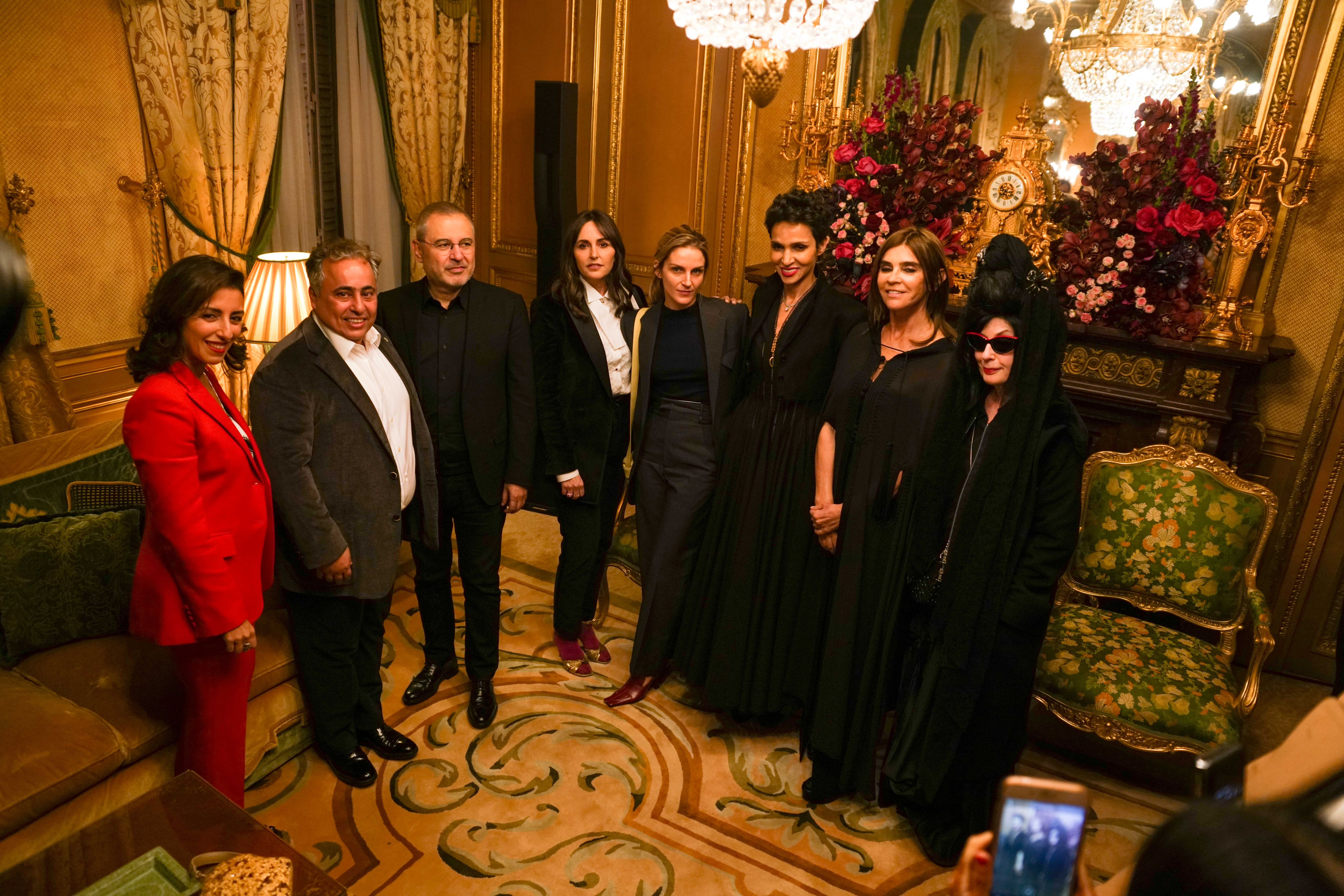 A group of 8 men and women smile during Fashion Trust Arabia at the Embassy of Qatar, Paris during Qatar-France 2020.