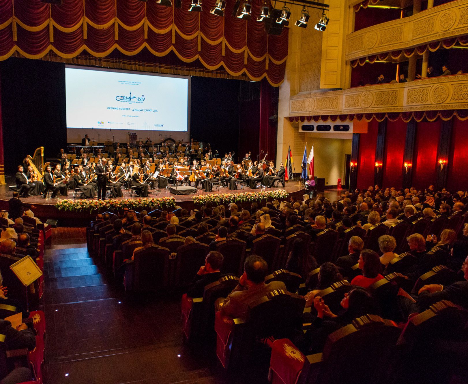 Beautiful auditorium with an audience watching a classical orchestra play during the Qatar-Germany 2017 opening concert.