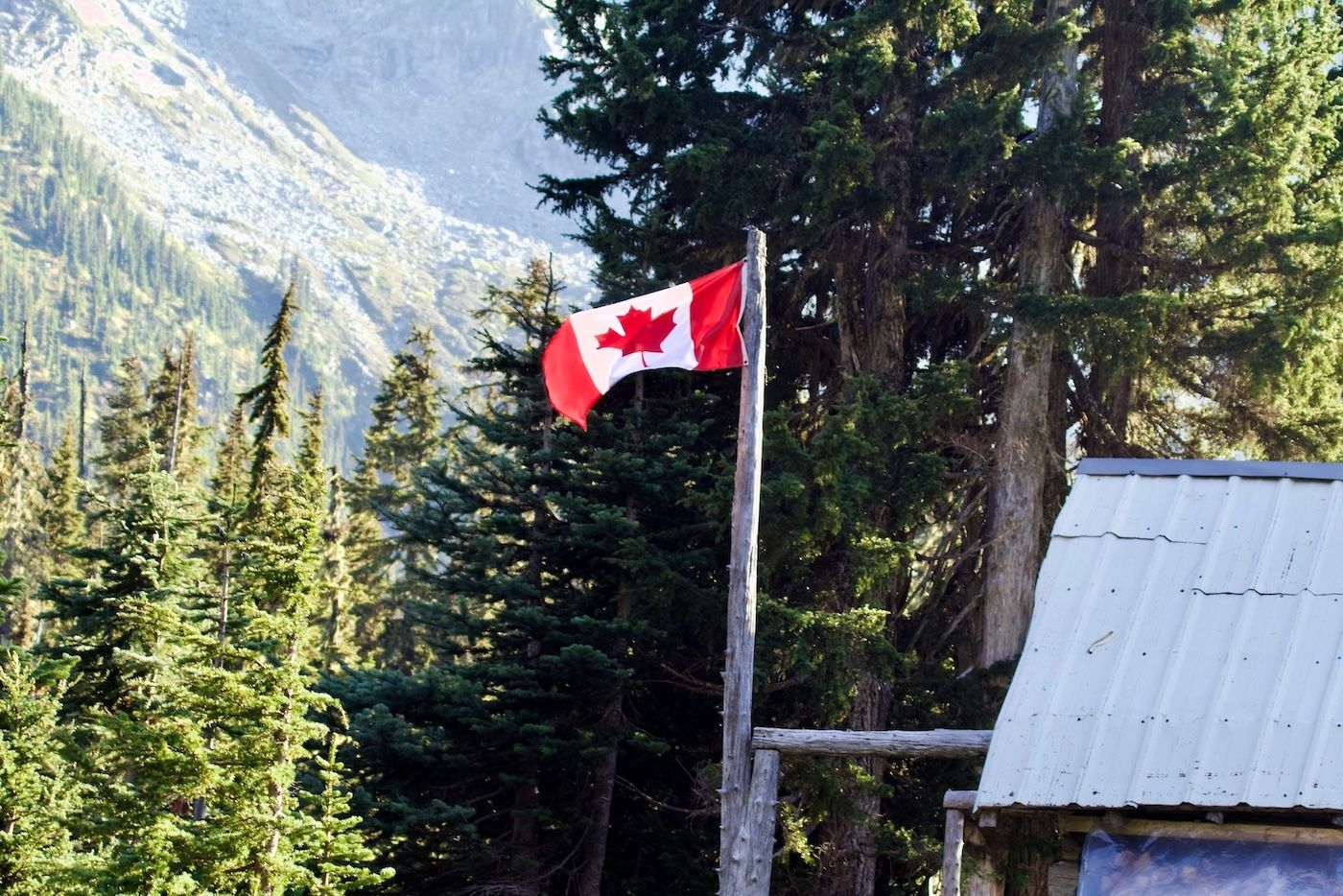 National Flag of Canada flying outdoor in a natural, mountainous setting - probably one of Canada's National Parks.