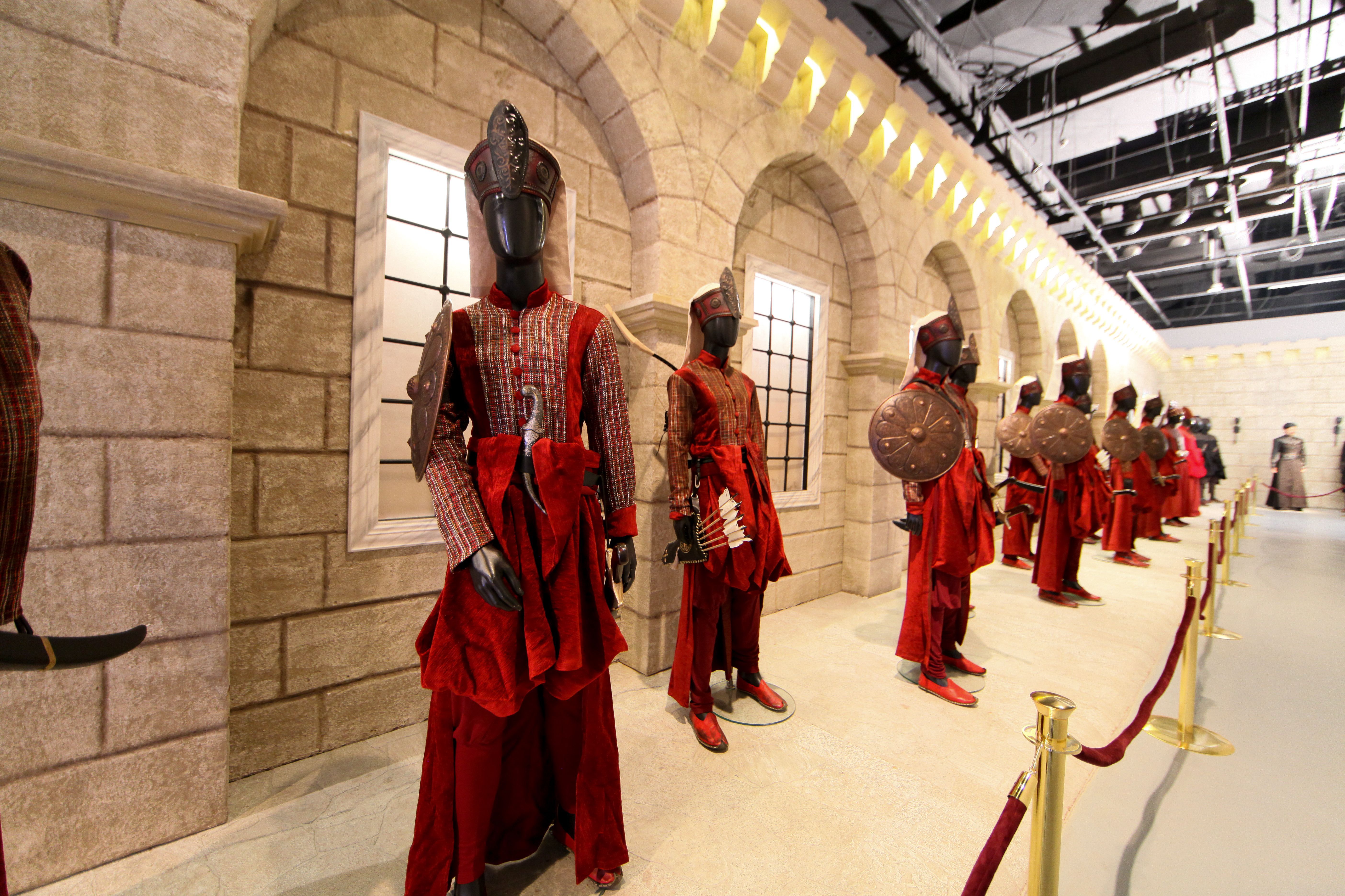 A series of red costumes on display at the Harem al Sultan exhibition at QM Gallery in Katara.