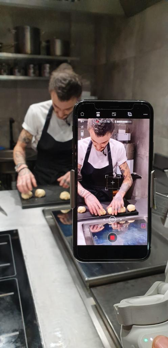 Smartphone filming French chef Guillaume Sanchez creating dishes in his kitchen to be live streamed during Qatar-France 2020.