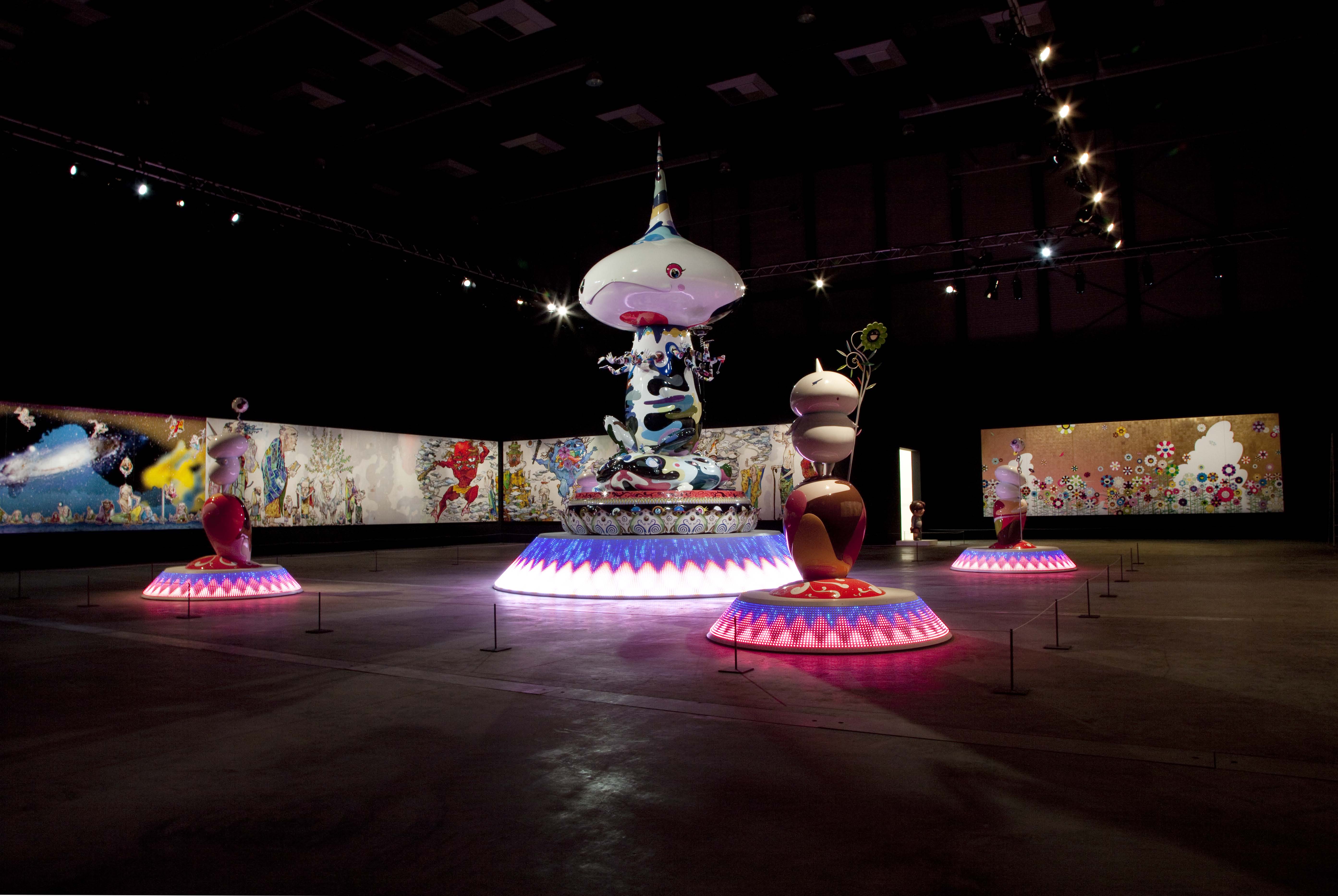 Illuminated sculptures on display in a wide exhibition space during Ego by Takashi Murakami in Qatar.