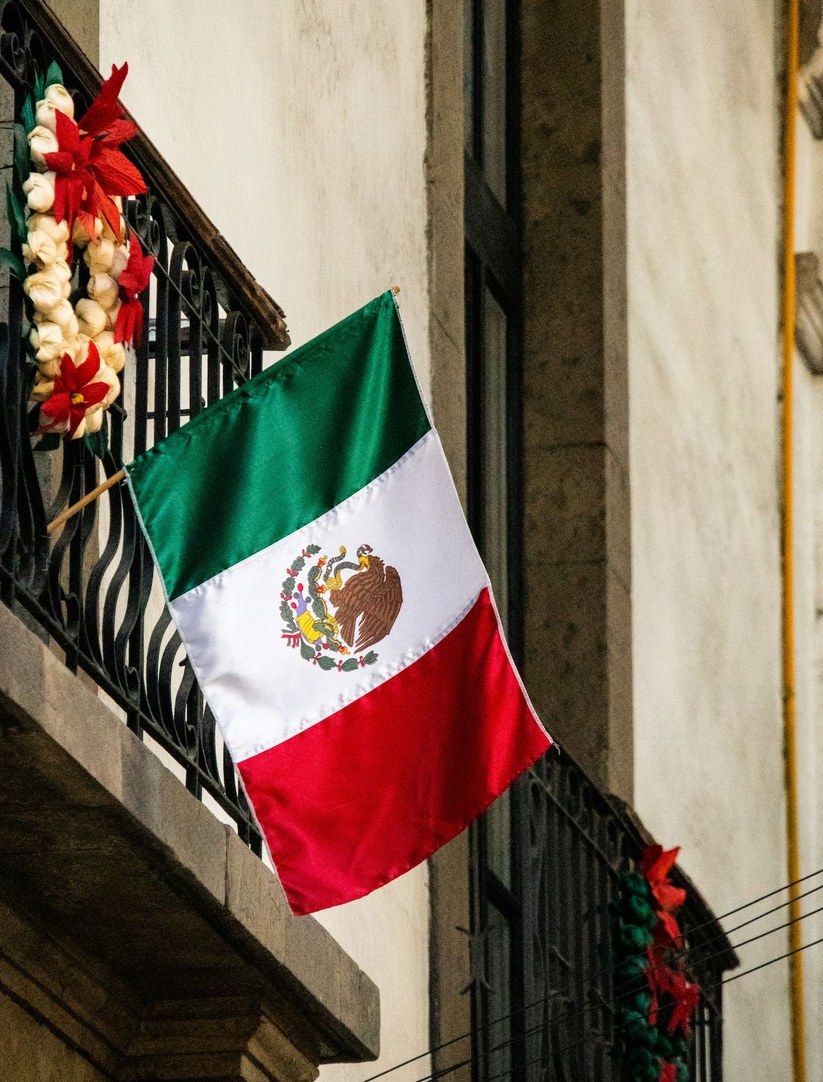 Mexican flag hanging from a balcony