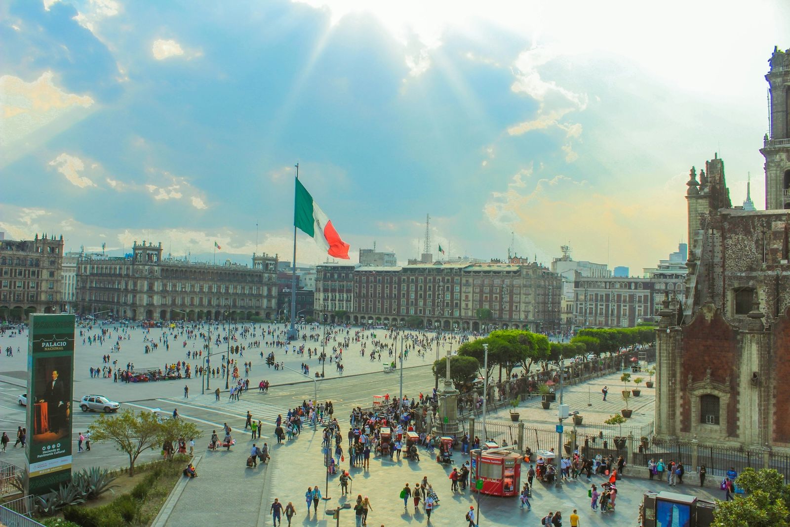 large mexican flag standing in the middle of Plaza de la Constitucion, the main square in Mexico City