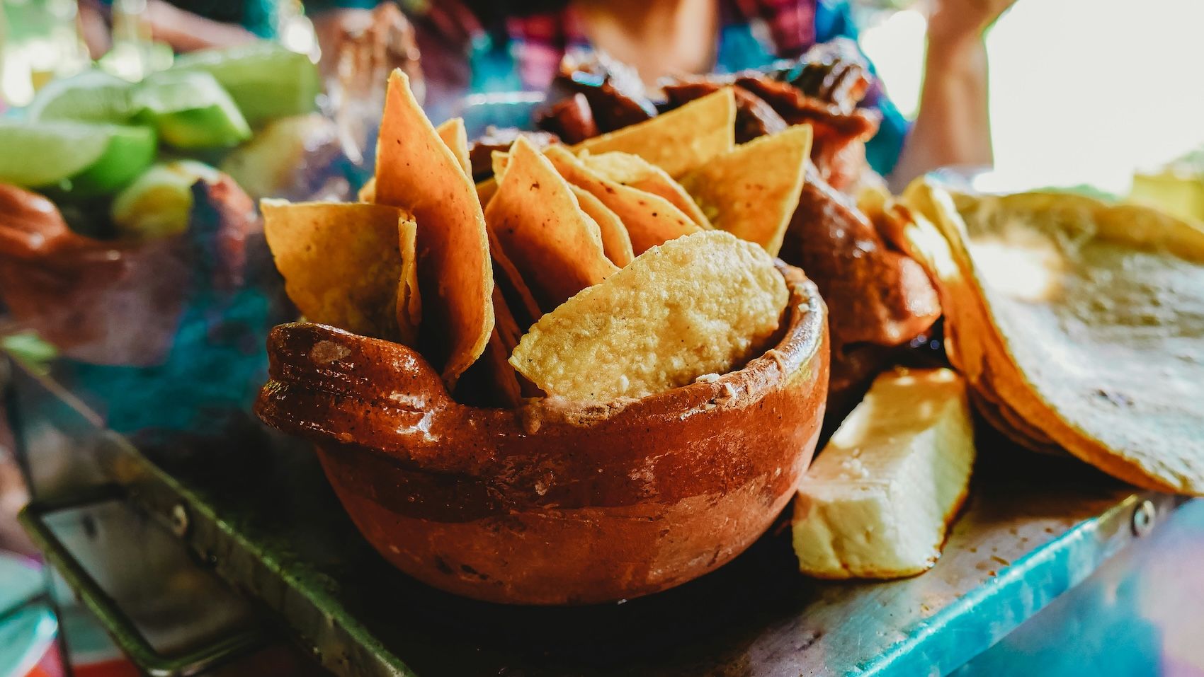 A bowl of totopos, a traditional Mexican tortilla chip commonly served as an appetizer.