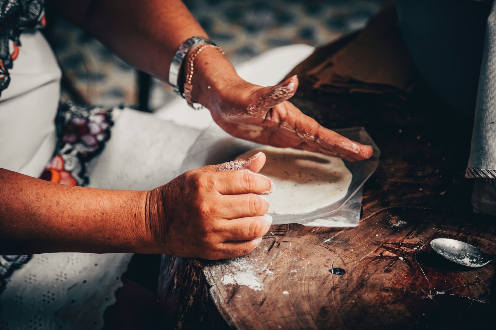 Close up image of the traditional process of making handmade corn tortillas, a staple in Mexican cuisine.