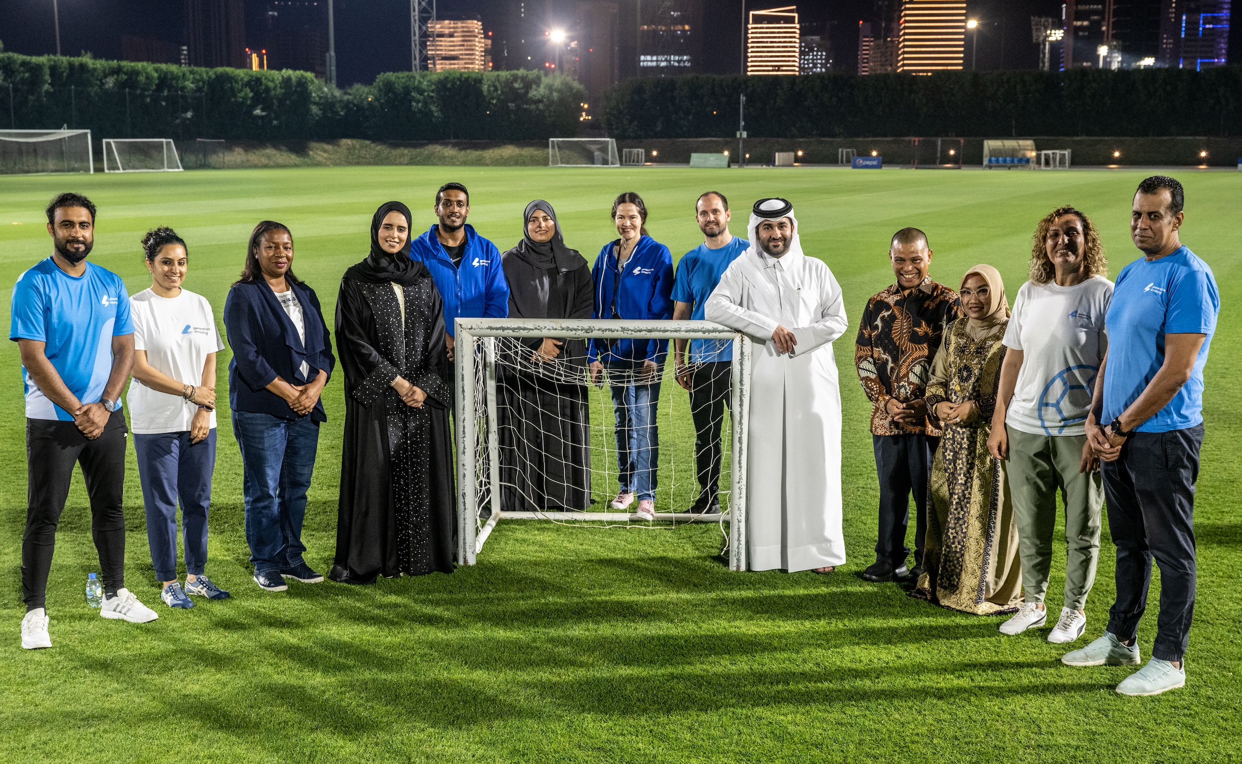 Group of coaches and officials at Generation Amazing children's football event in Qatar.