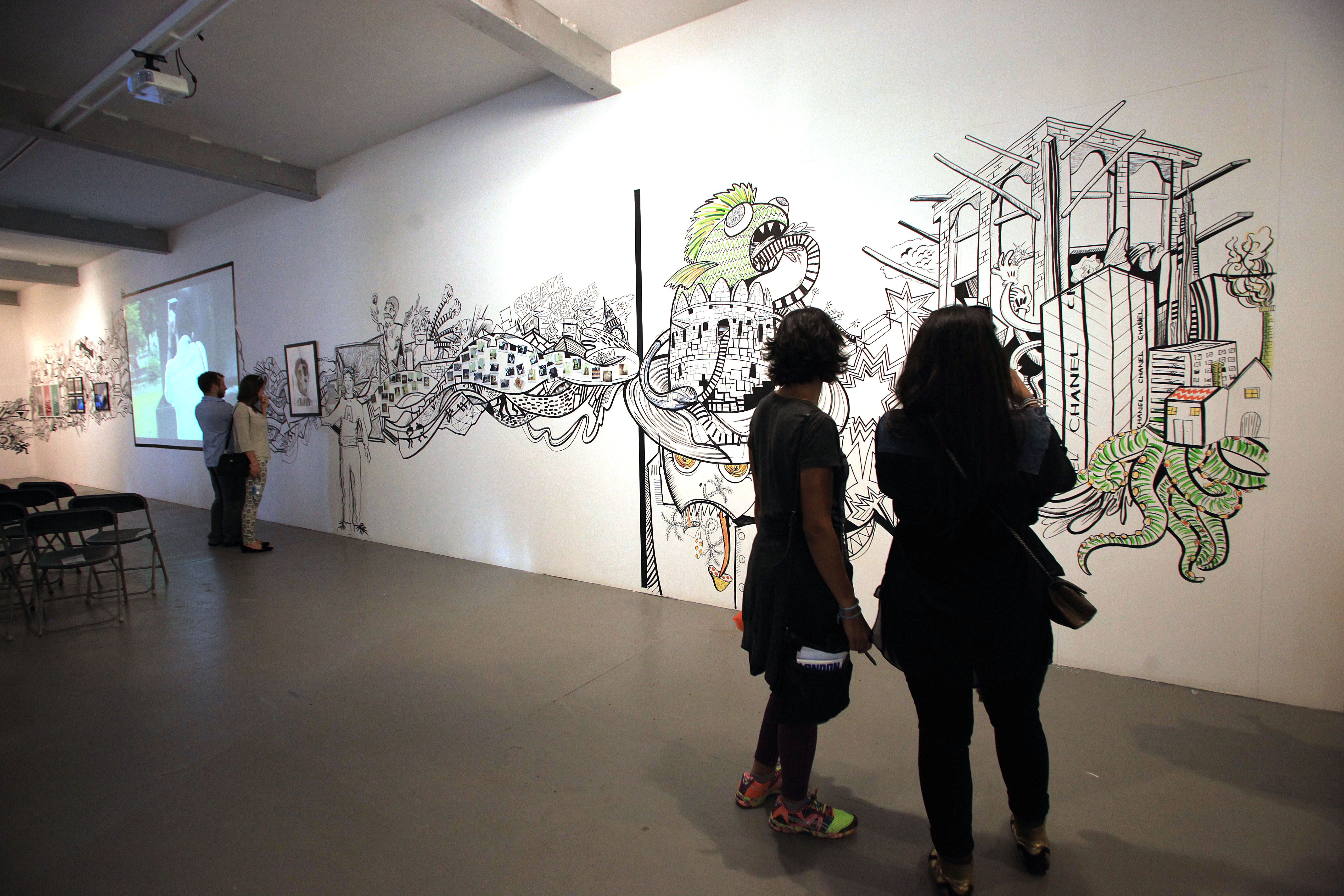 Visitors admire a mural across a gallery wall in London during Create & Inspire, part of the Qatar-Uk 2013 Year of Culture.