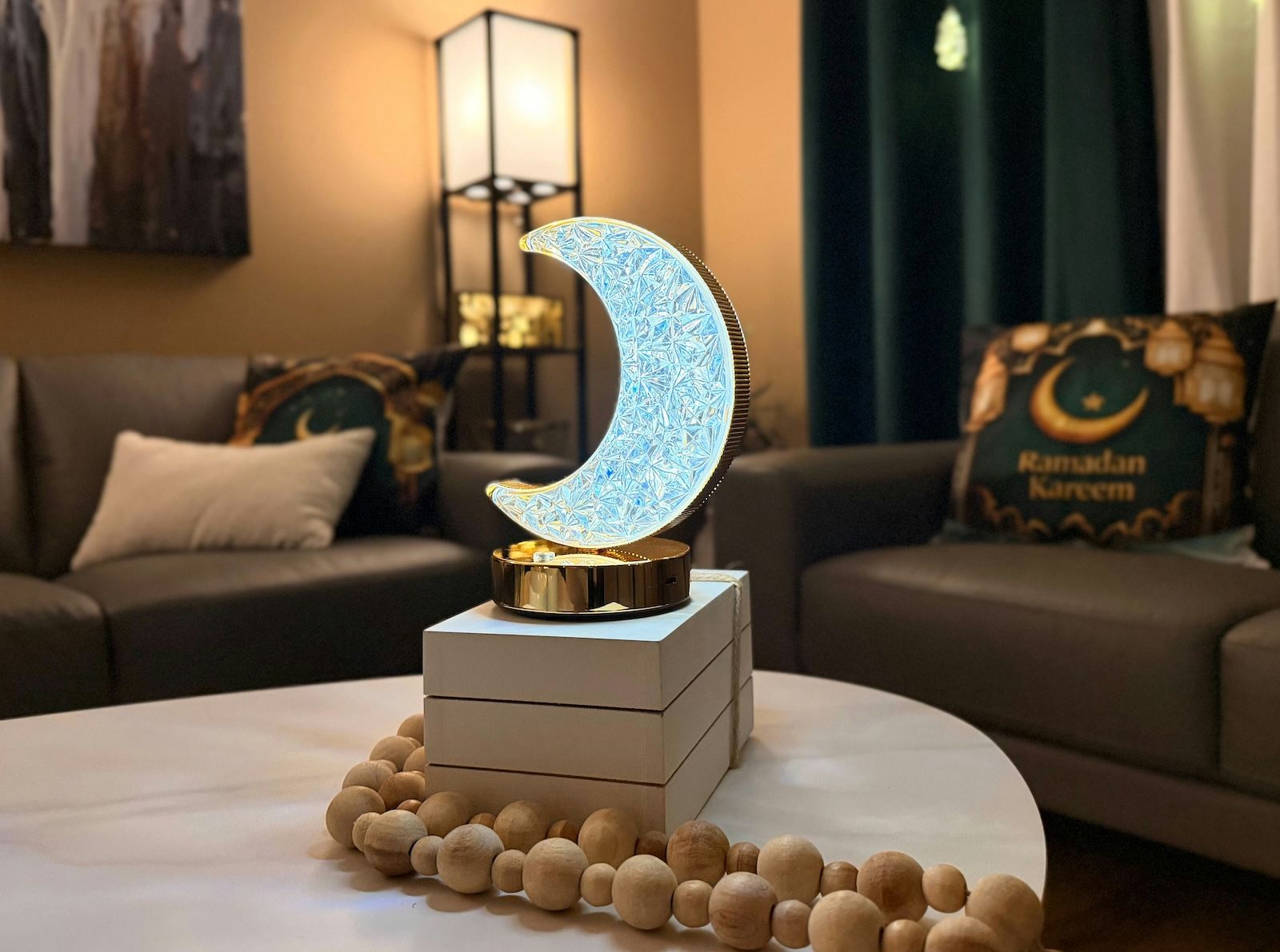 A crescent moon-shaped crystal LED table lamp, a typical decorative Ramadan night light.