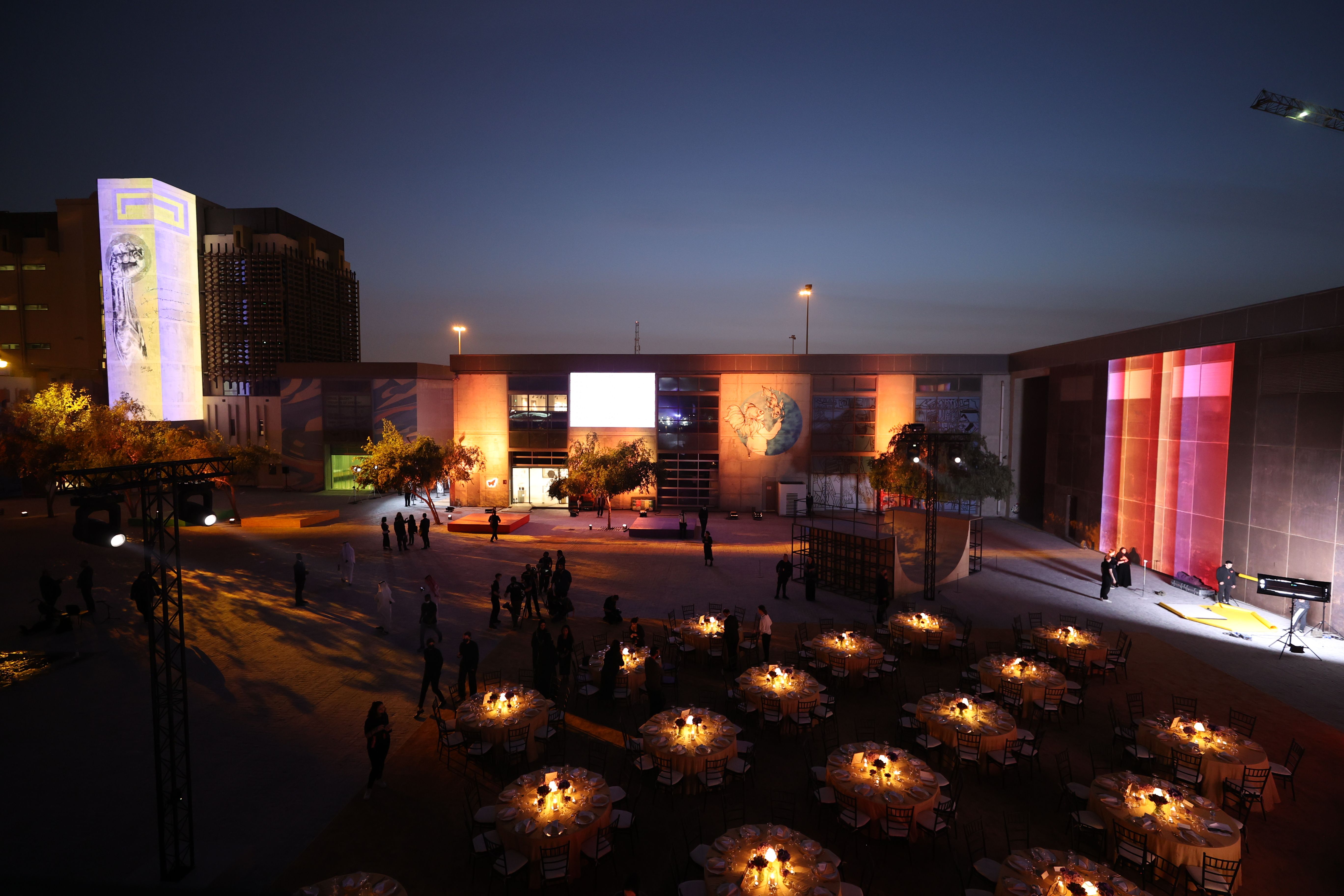 The atmospheric courtyard of the Fire Station at night, set up with round dining tables for a gala dinner with soft lighting.The atmospheric courtyard of the Fire Station at night, set up with round dining tables for a gala dinner with soft lighting.