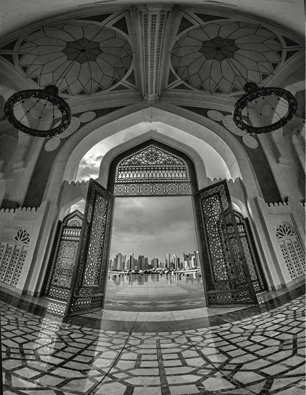 Looking out through the doorway of a mosque towards the city skyline, during the Qatar-India 2019 photography exchange. 