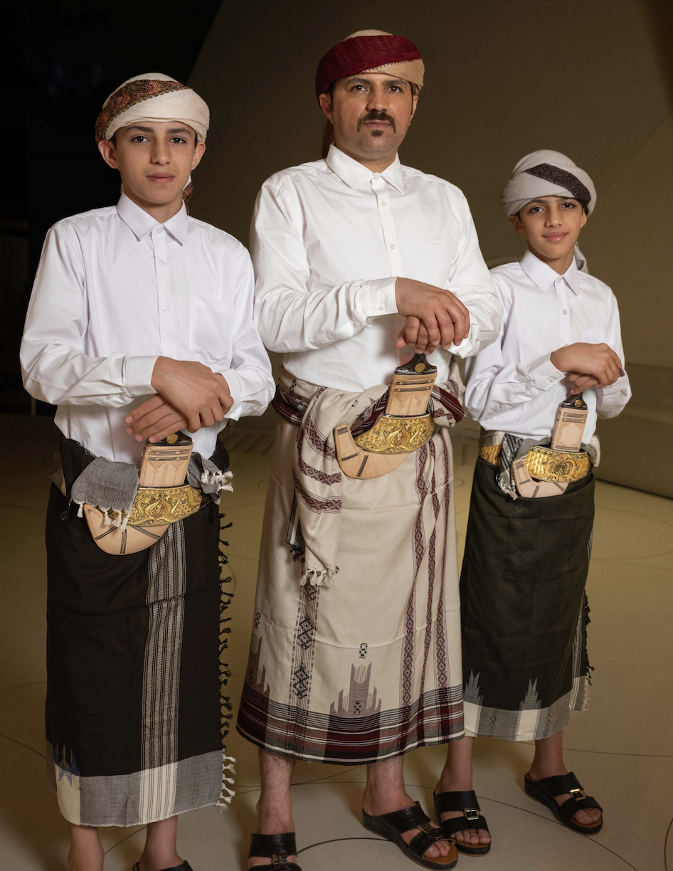 A man and two boys model traditional Yemeni outfits from Al-Bayda’ in a Yemeni Fashion Showcase during Qatar-MENASA 2022.