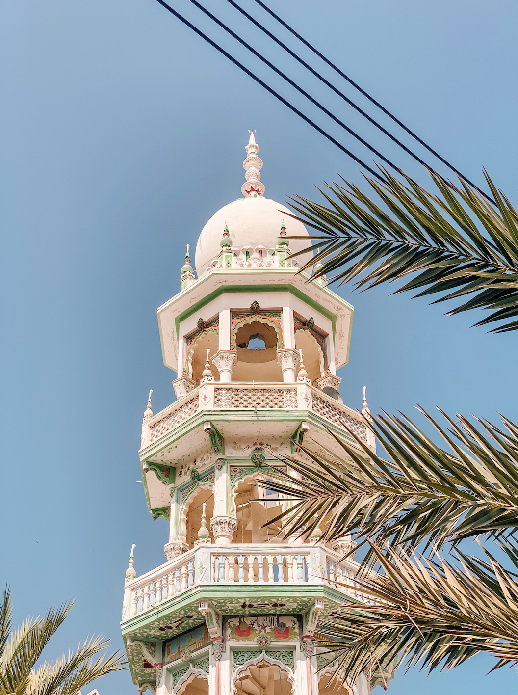 The ornate painted tower of a Mosque in Mutrah, Oman captured by photographer Israa Al Balushi as part of Marchitecture.