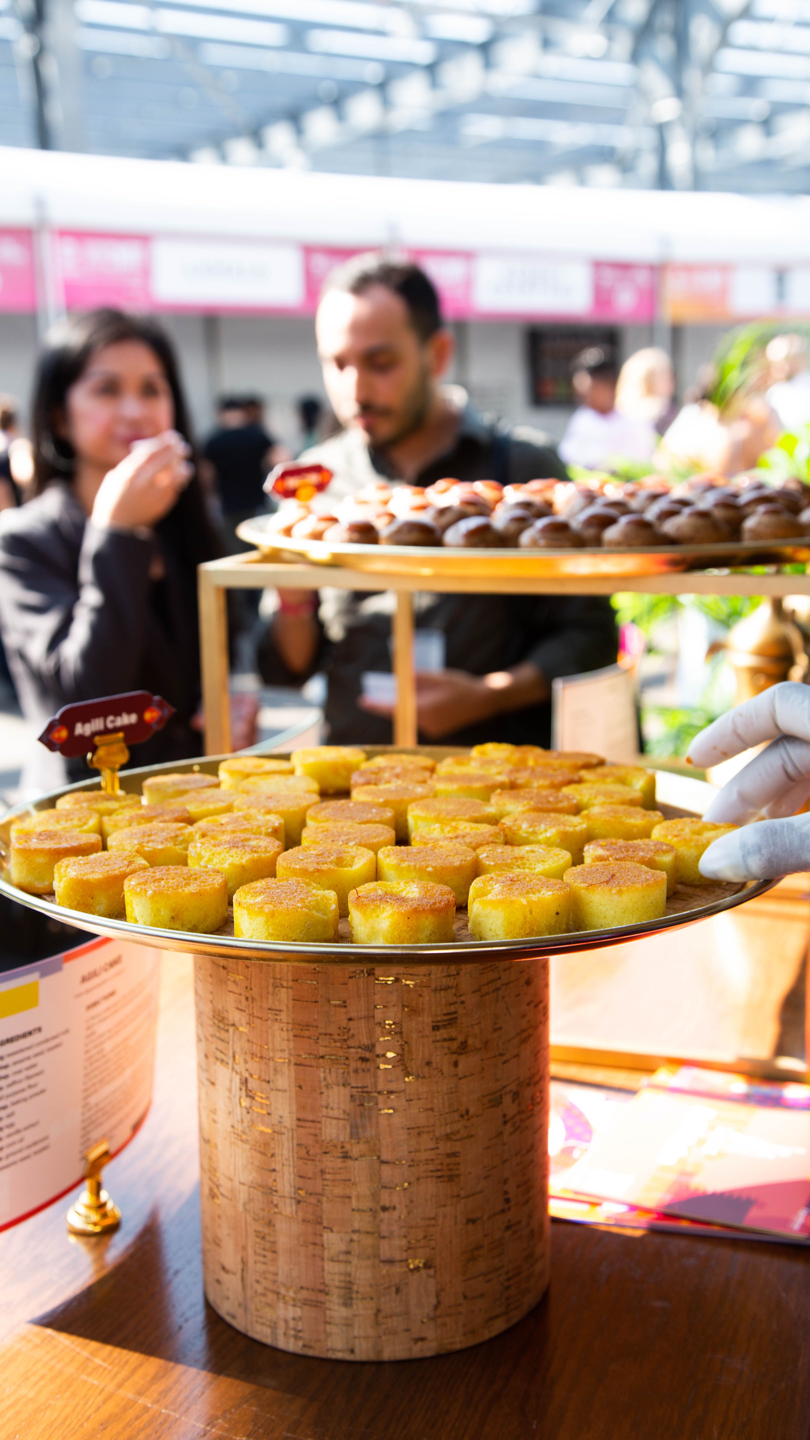 A platter of Qatari Agili cakes on a cake stand for guests to taste at the New York Food Festival during Qatar-USA 2021.