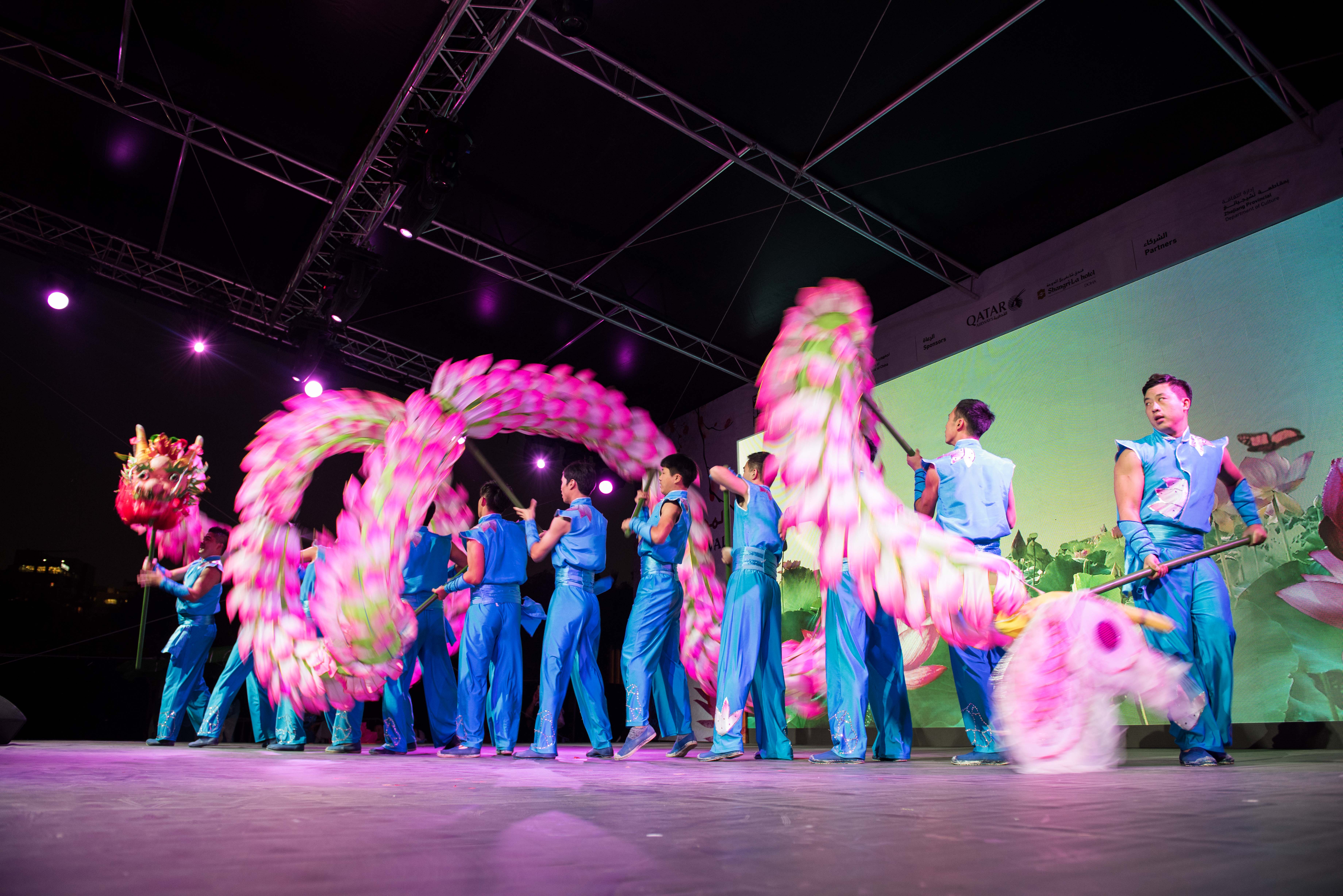 Chinese dancers perform a traditional dragon dance on stage during The Chinese Festival in Qatar.