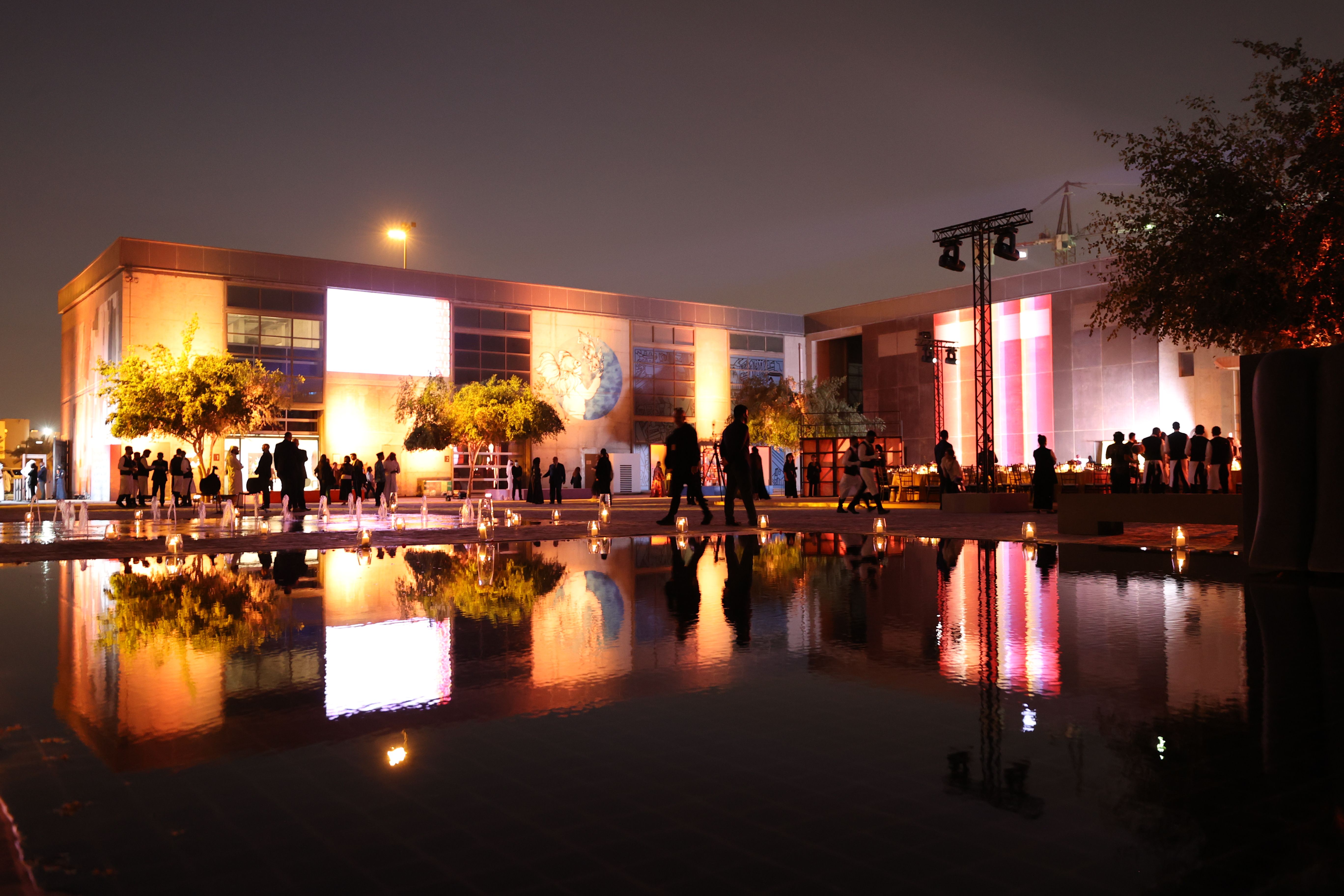 The Fire Station courtyard at night, lit in soft orange and pink lights for guests of the Years of Culture opening ceremony.