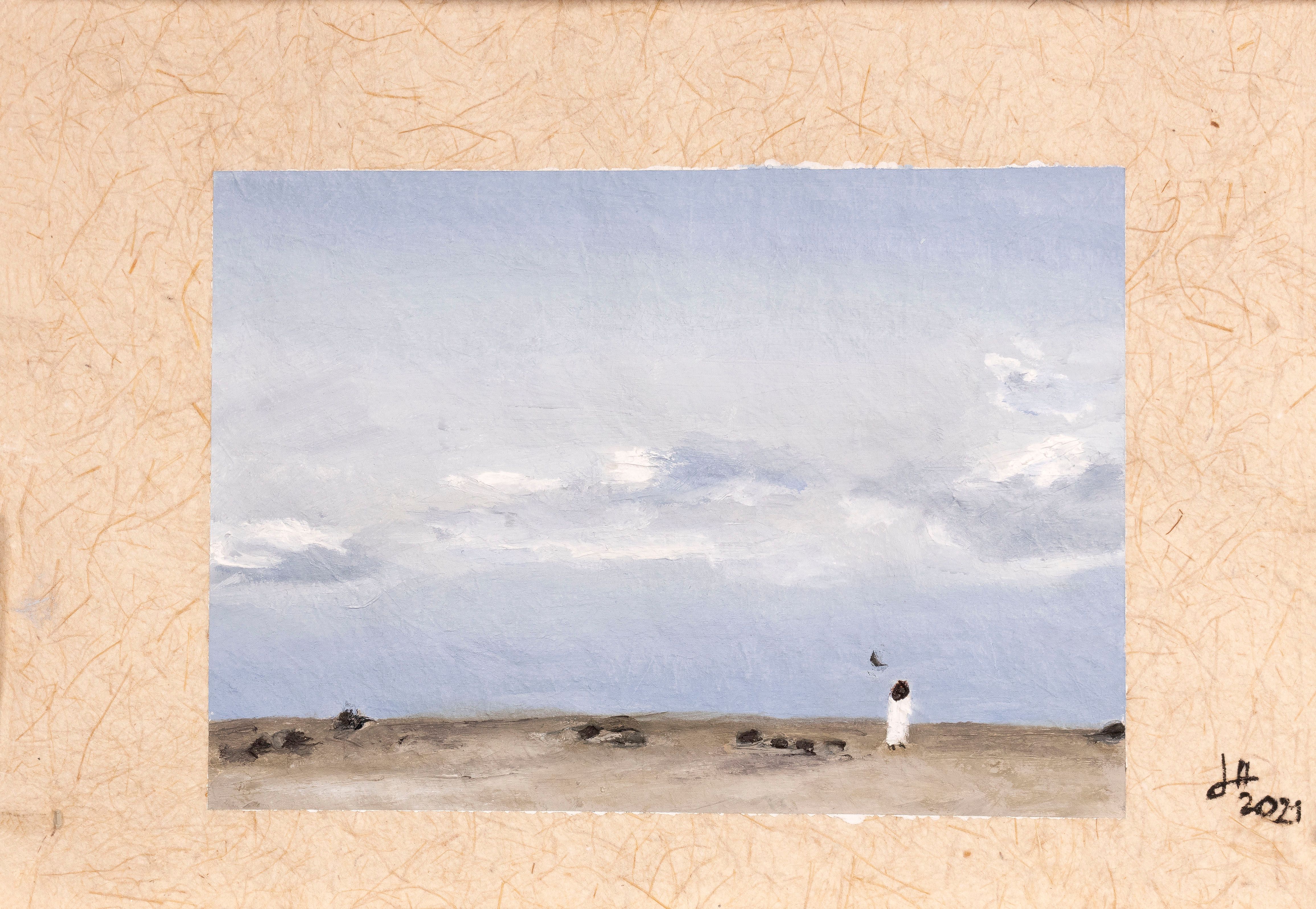 Painting of a woman standing far away on a beach, looking out at a blue grey sky, framed with handmade paper.