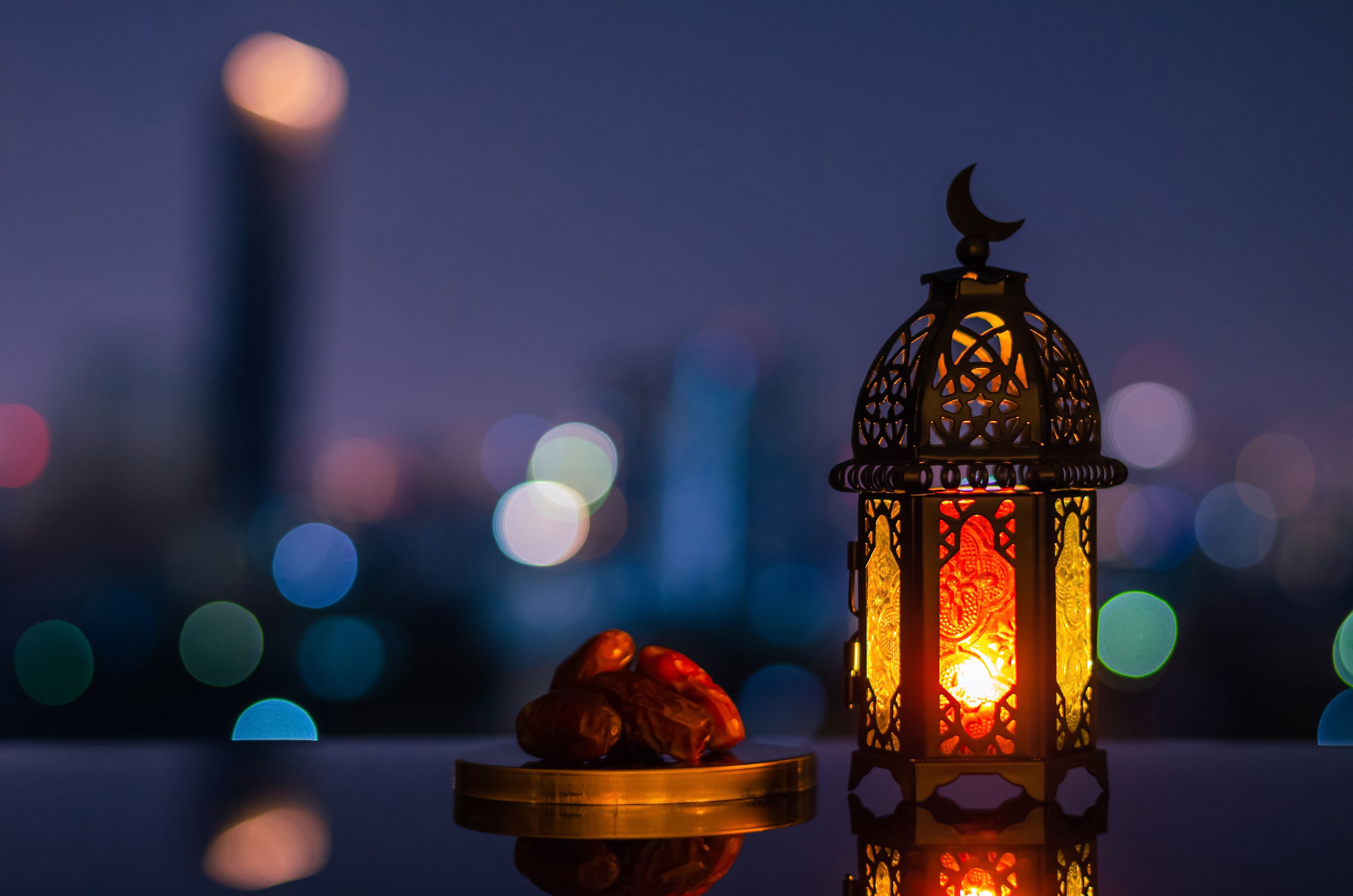 Colourful lantern and bowl of dates during Iftar in Qatar.