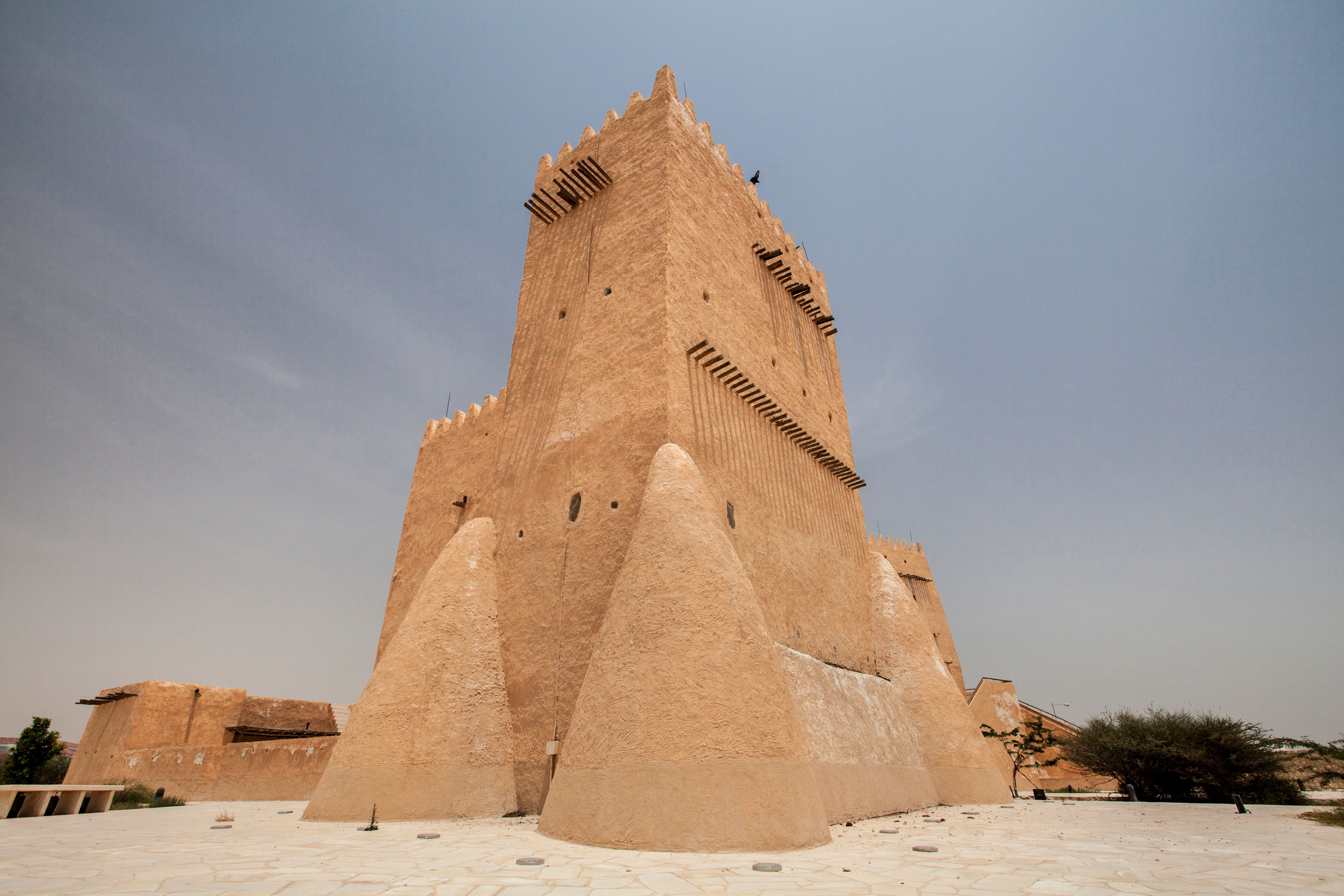 Barzan watchtower in a desert landscape against a blue sky taken during the Qatar Brazil Photography Expedition & Exhibition.